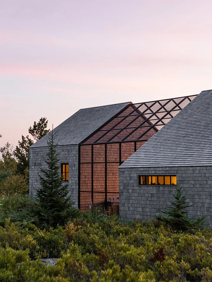 Cedar shingled house exterior with mush porch connecting two buildings.