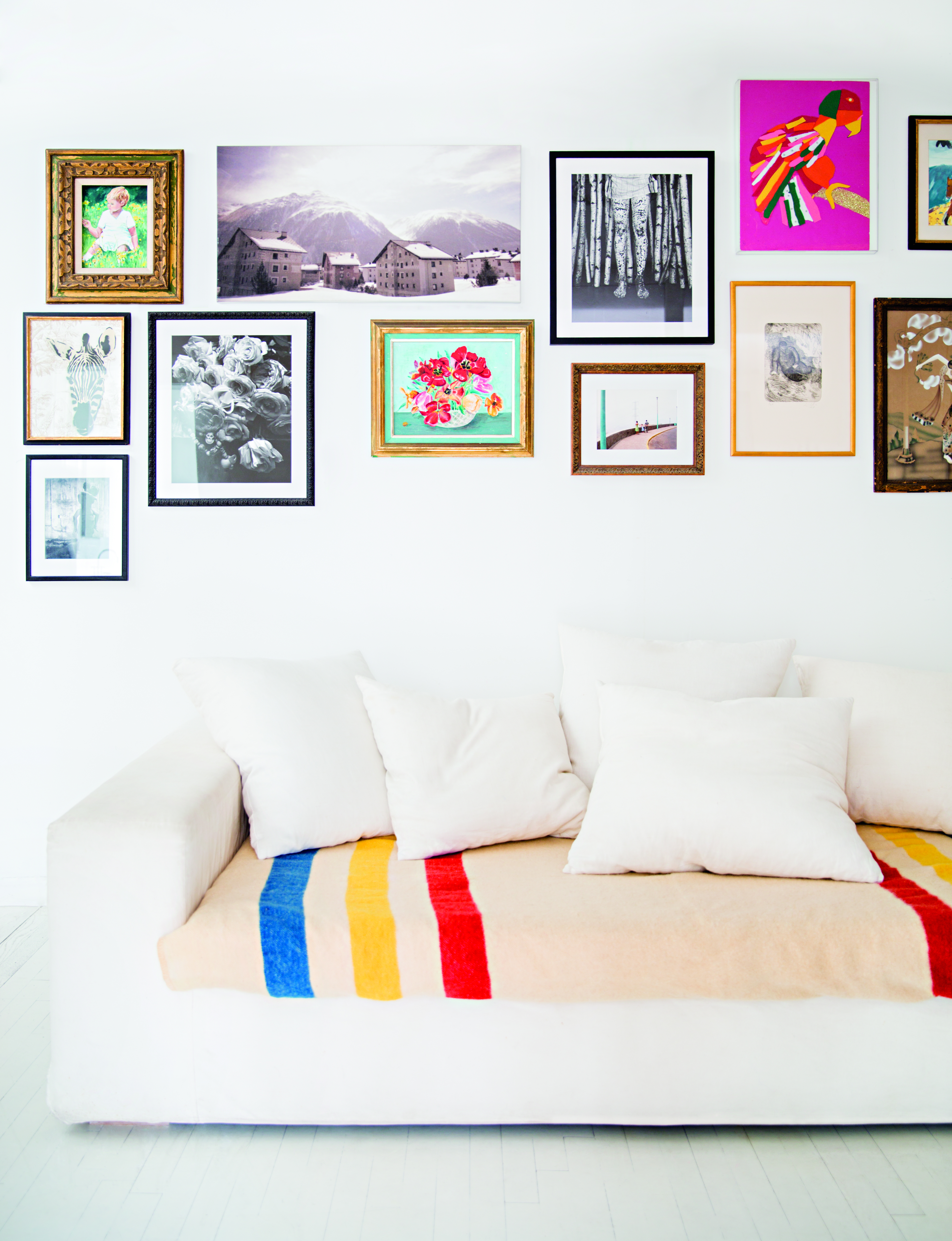 gallery wall above white sofa