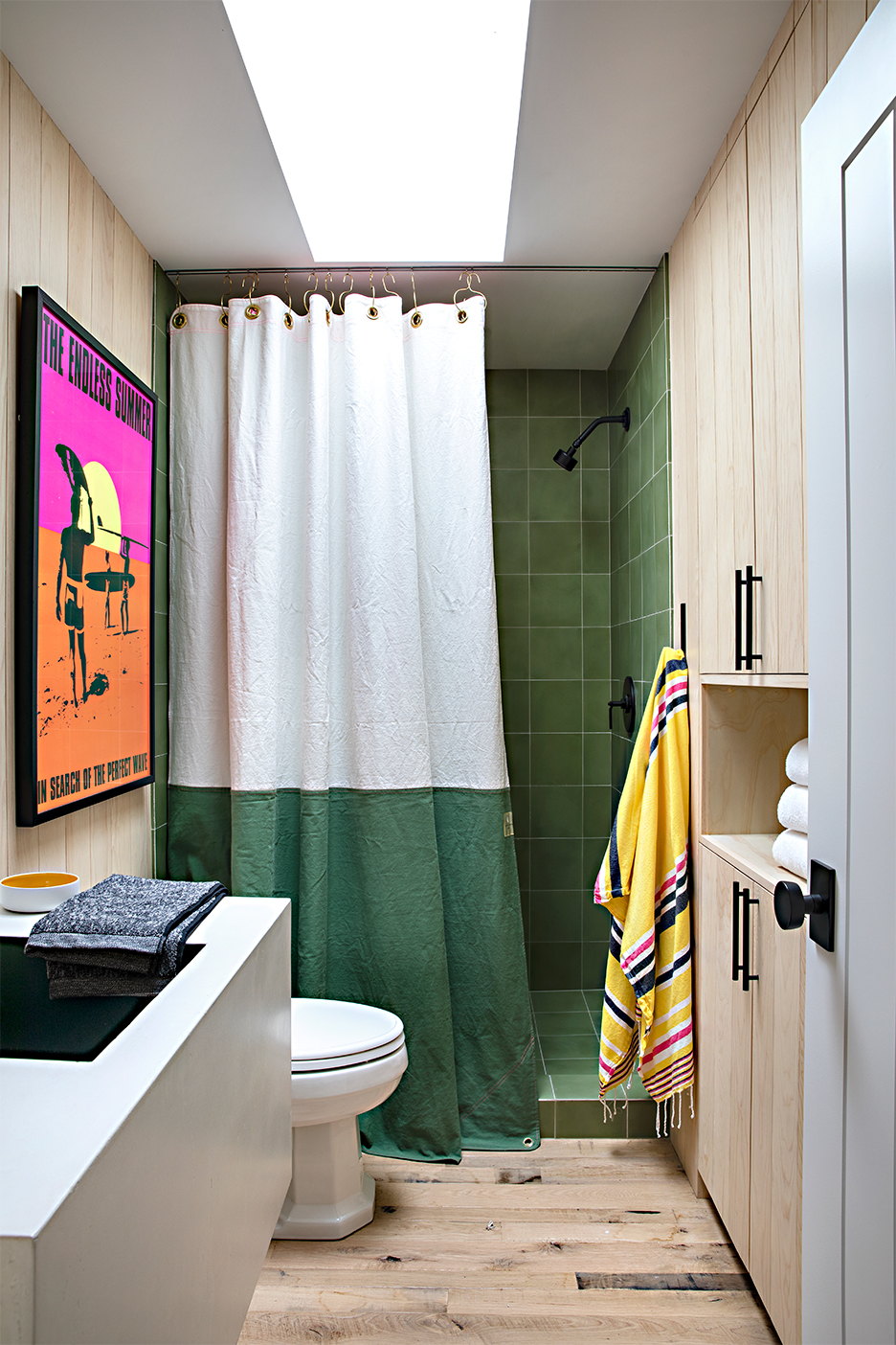 wood bathromo with green tile shower