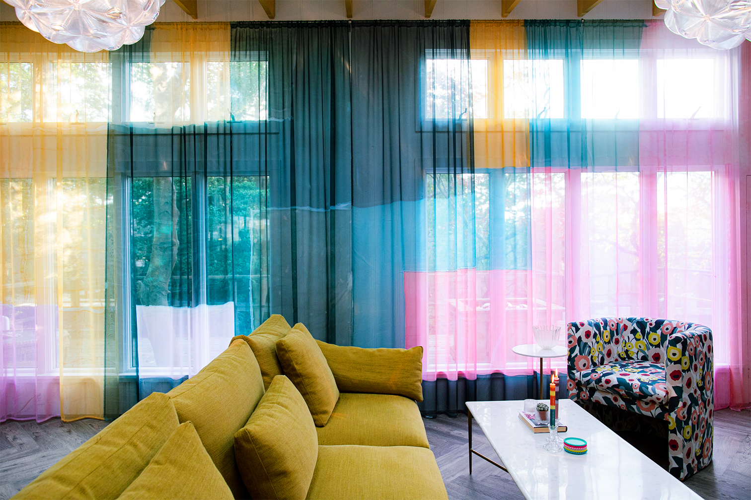 Living room with floor to ceiling rainbow curtains