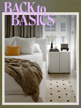 bed with white bedding and embroidered pillows and brown throw