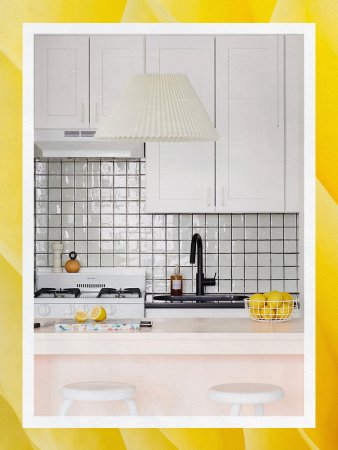 pink kitchen island with white cabinets and peel-and-stick backsplash