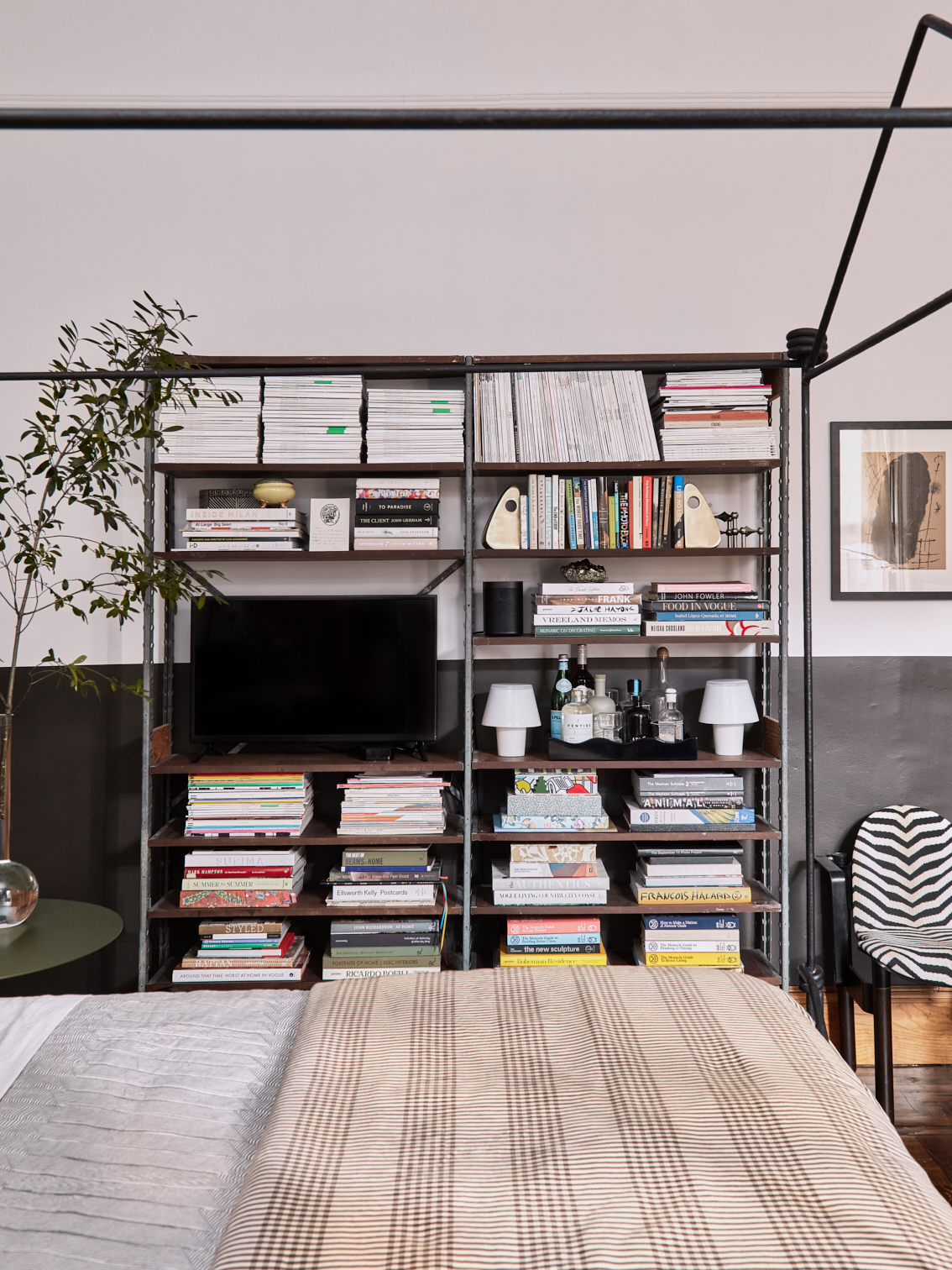 large bookshlf next to bed