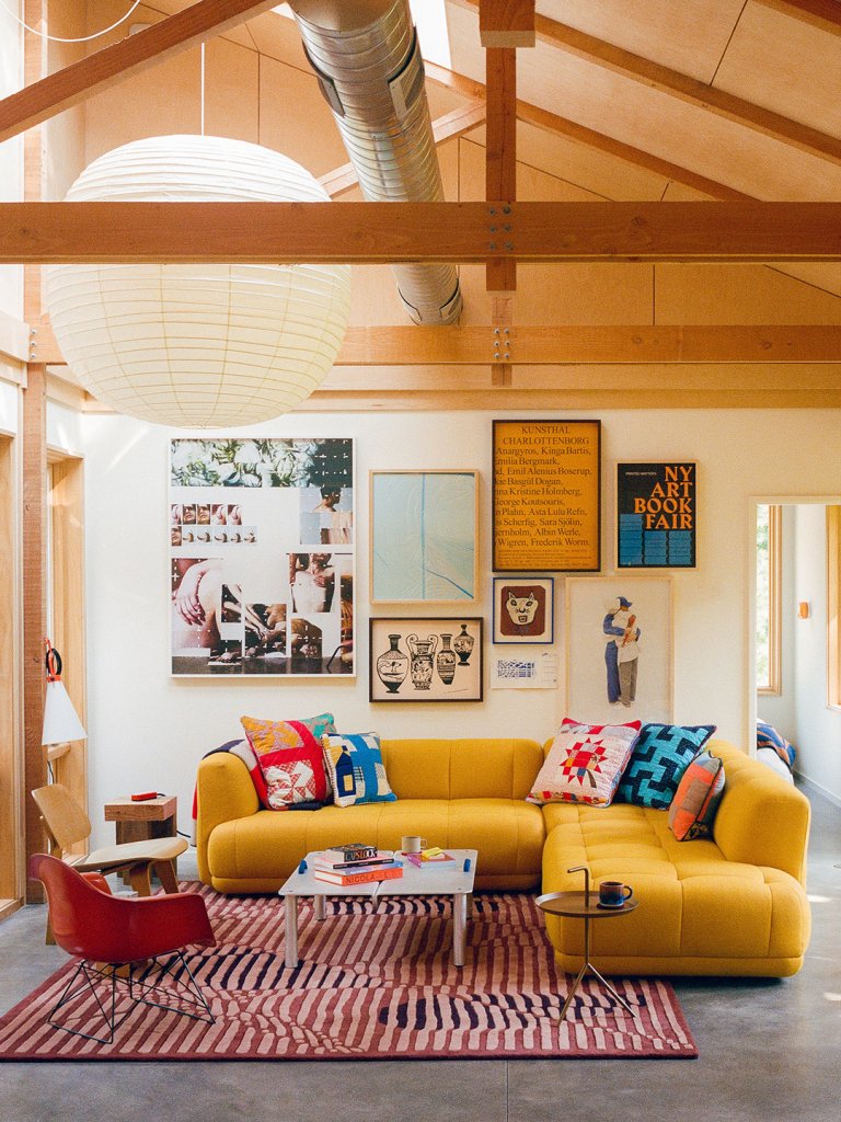 Living room with vaulted ceilings and yellow sofa