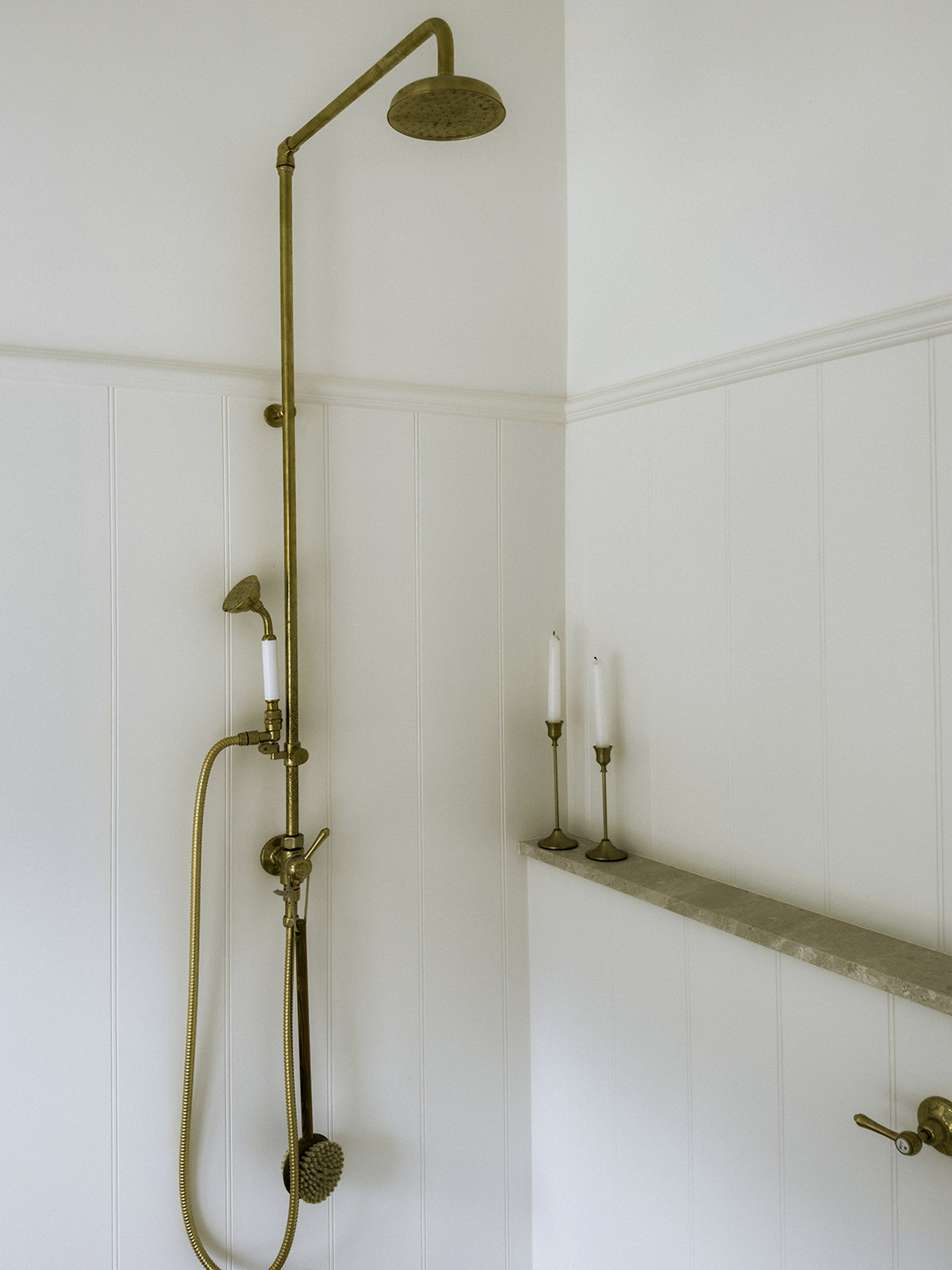 White tongue-and-groove style paneling in a shower area